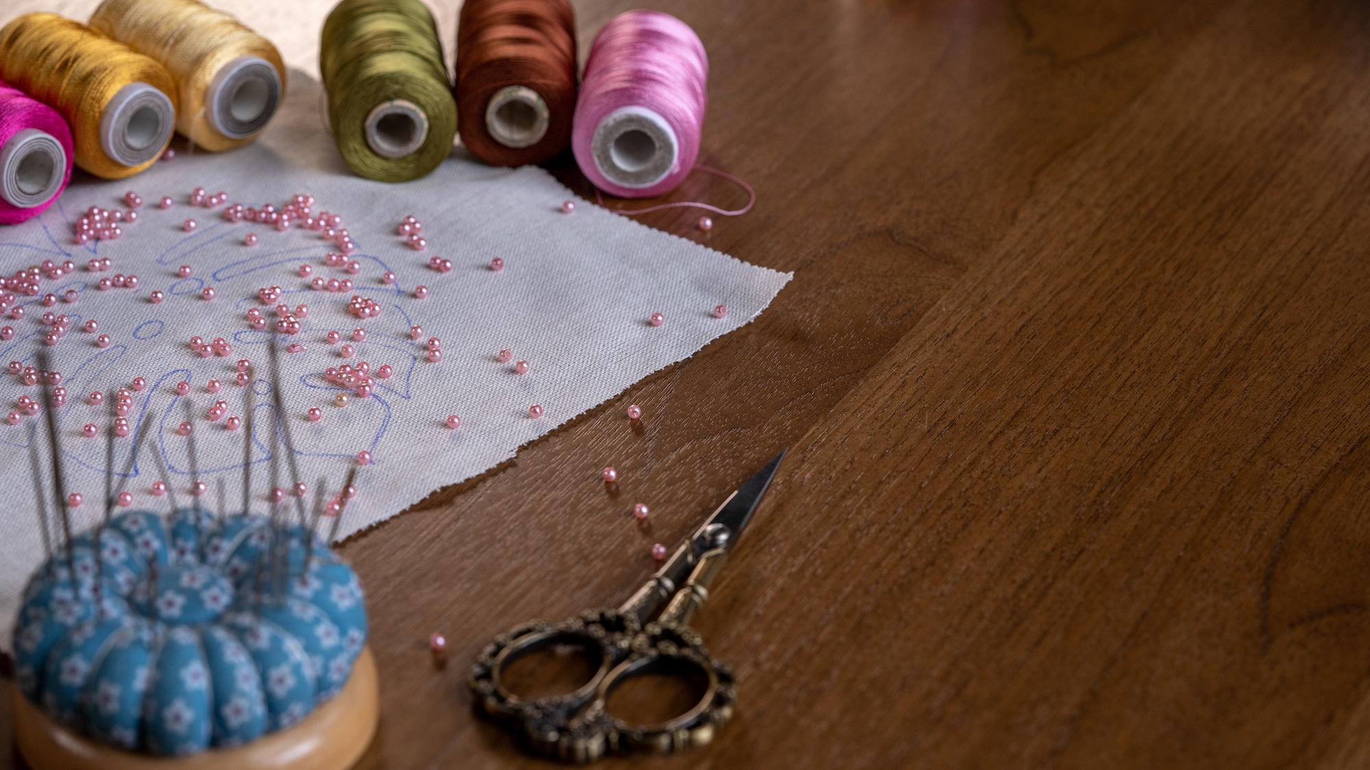 atelier workspace with embroidered samples on table